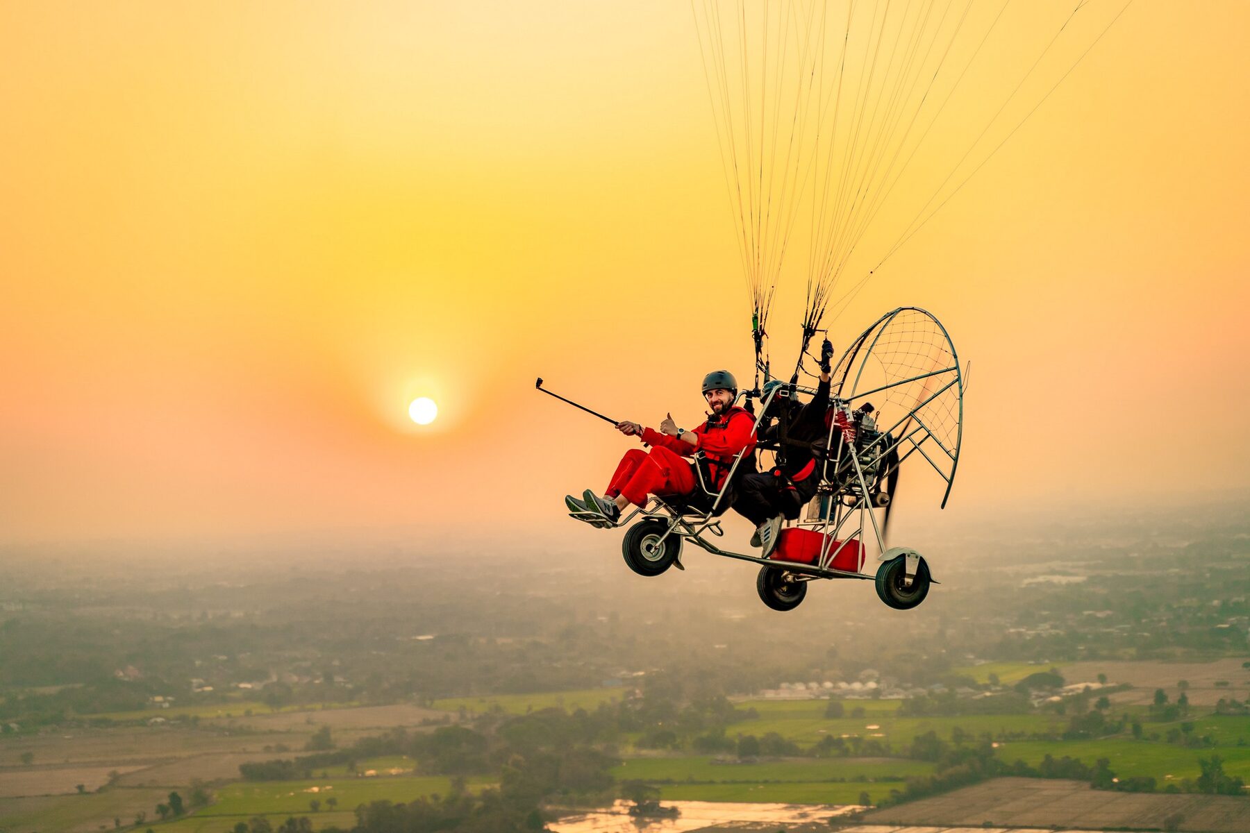 Tandem paramotor flying above the mountains of Chiang Mai