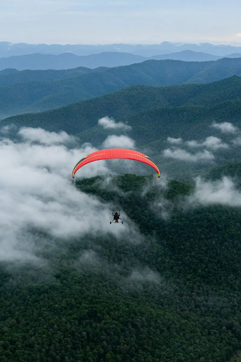 Tandem paramotor above the clouds